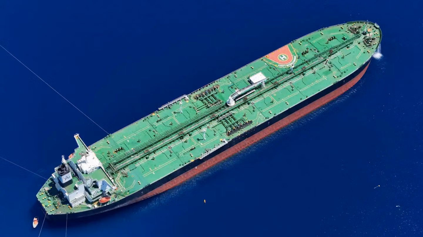 Aerial shot of an oil tanker sailing in the ocean near Vado Ligure, Italy.